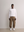 Model wears A.B.C white kyneton relaxed fit long sleeve crewneck knit top made of 100% Good Earth Cotton.