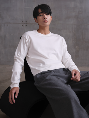 Model wears A.B.C kyneton relaxed fit long sleeve crewneck knit top made of 100% Good Earth Cotton.