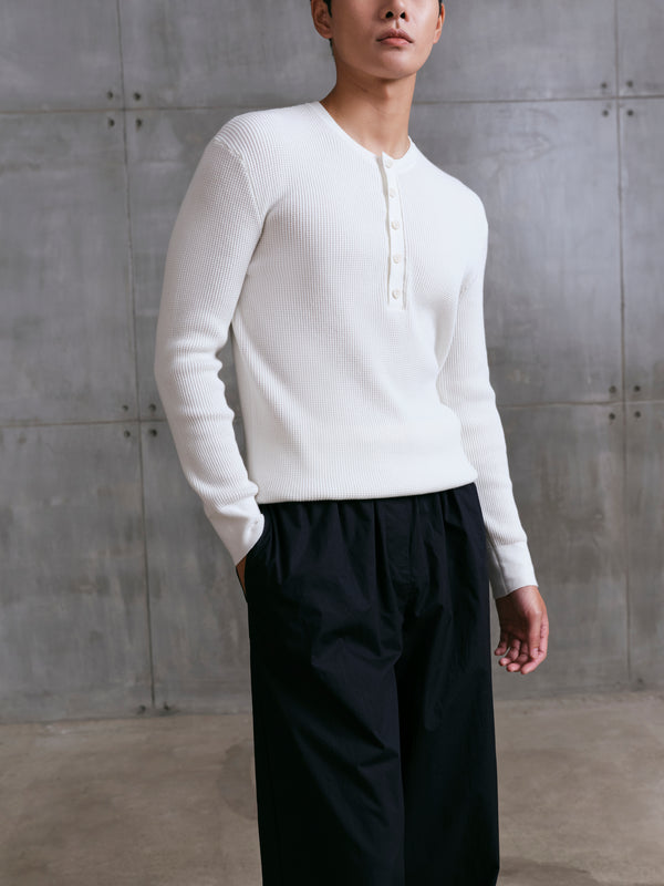 Detail shot of the breathable waffle-weave fabric on the AK06 long-sleeve shirt in ivory.