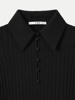 Close up of the structured collar and buttons on the black A.B.C A BRAND COLLECTIVE wide rib top.