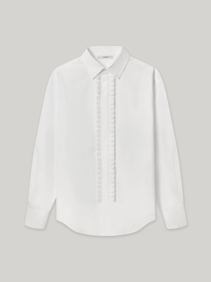 Moree Ruffle Dress Shirt is a white long-sleeve dress shirt with a ruffle front panel running down the centre — a formal detail reinterpreted for everyday wear. Features a classic point collar, a hidden button placket beneath the ruffle, and buttoned cuffs. 