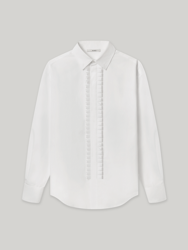 Moree Ruffle Dress Shirt is a white long-sleeve dress shirt with a ruffle front panel running down the centre — a formal detail reinterpreted for everyday wear. Features a classic point collar, a hidden button placket beneath the ruffle, and buttoned cuffs. 