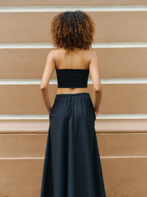 Minimalist back view of the black Preston bandeau paired elegantly with high waisted styles.