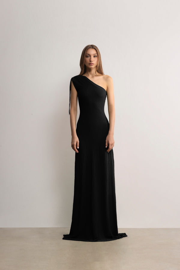 Women model wearing a black one-shoulder removable dress by A.B.C - A BRAND COLLECTIVE.