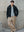 Model wearing the grey Kyneton knit polo under a black jacket A.B.C A BRAND COLLECTIVE versatile layering piece