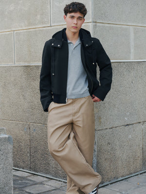 Model wearing the grey Kyneton knit polo under a black jacket A.B.C A BRAND COLLECTIVE versatile layering piece