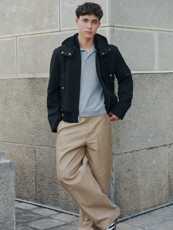 Model wearing the grey Kyneton knit polo under a black jacket A.B.C A BRAND COLLECTIVE versatile layering piece