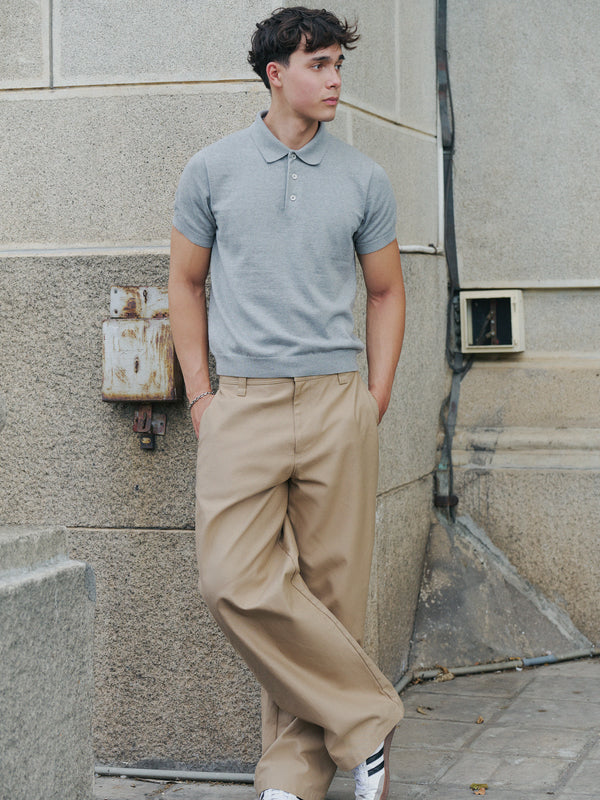 Model styling the grey marle Kyneton knit polo with tan trousers A.B.C A BRAND COLLECTIVE climate positive cotton