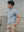 Side view of Kyneton regular fit knit polo in grey marle A.B.C A BRAND COLLECTIVE short sleeved textured knit