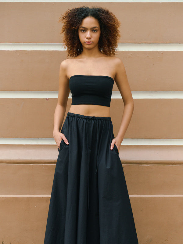 Confident model styling the black Preston bandeau with a flowy skirt for a modern A.B.C A BRAND COLLECTIVE look.