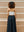 Modern aesthetic from behind featuring the white Preston top and a contrasting black maxi skirt.