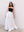 Stylish model wearing a black midi bandeau paired with a white high waisted skirt for a confident modern aesthetic.