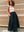 Model styling a white midi bandeau with a flowy black maxi skirt for a relaxed street look A.B.C A BRAND COLLECTIVE.