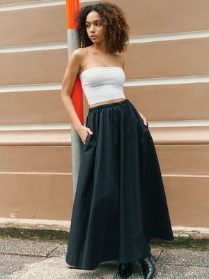 Model styling a white midi bandeau with a flowy black maxi skirt for a relaxed street look A.B.C A BRAND COLLECTIVE.