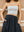Elongated torso coverage of the white midi bandeau showing a secure and streamlined fit A.B.C A BRAND COLLECTIVE.