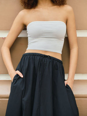 Elongated torso coverage of the white midi bandeau showing a secure and streamlined fit A.B.C A BRAND COLLECTIVE.