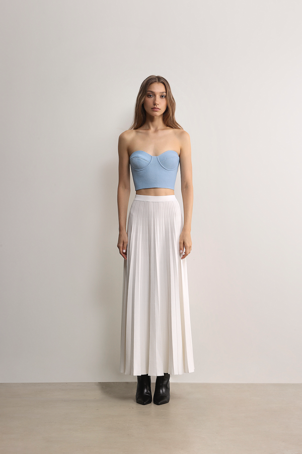 Model styling the sky blue A.B.C A BRAND COLLECTIVE bustier with a white maxi skirt for a fresh aesthetic