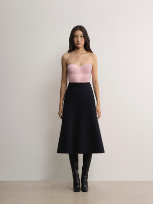Model pairing the pink A.B.C A BRAND COLLECTIVE bustier with a black skirt for an elegant contrast.