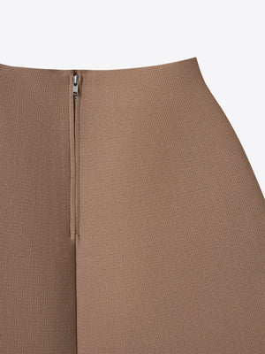 Close-up of the secure metallic back zipper on the beige A.B.C A BRAND COLLECTIVE knit skirt.