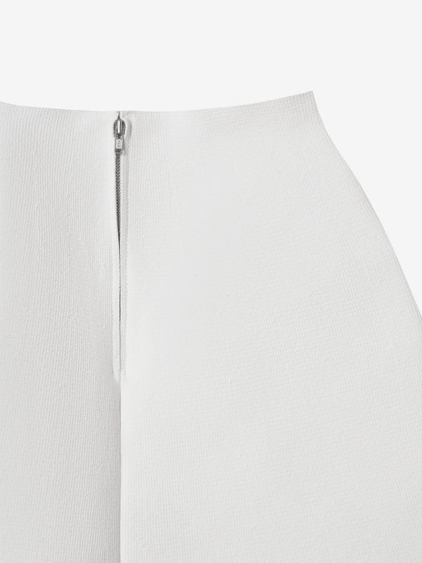 Close-up of the clean finish and zipper on the ivory A.B.C A BRAND COLLECTIVE knit skirt.