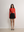 Model styling the red Rosebery Keyhole Cut-Out top with a black mini skirt A.B.C A BRAND COLLECTIVE effortless sophistication