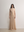Model in A.B.C A BRAND COLLECTIVE beige dress; showcasing clean lines and a refined, effortless smart-casual style.