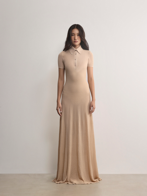 Model in A.B.C A BRAND COLLECTIVE beige dress; showcasing clean lines and a refined, effortless smart-casual style.