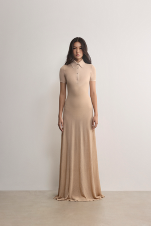 Model in A.B.C A BRAND COLLECTIVE beige dress; showcasing clean lines and a refined, effortless smart-casual style.