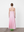 Woman wearing a pink dress with a white background A.B.C - A Brand Collective