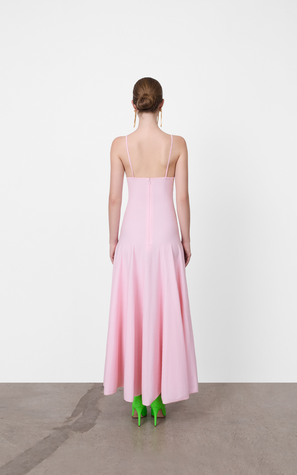Woman wearing a pink dress with a white background A.B.C - A Brand Collective