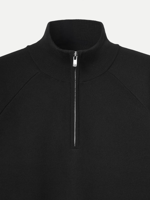 Close-up zip on black Glenorchy polo by A.B.C A BRAND COLLECTIVE, precise finish with a clean neckline and soft inner layer.