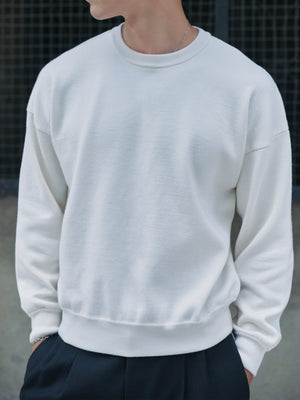 Detail view of the Ivory Glenorchy Crew Neck Sweater on model A.B.C A BRAND COLLECTIVE
