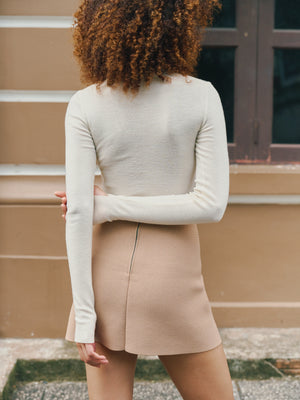 Back view of the ivory Mona Full Needle Rib Merino Wool Turtle Neck Top A.B.C A BRAND COLLECTIVE durable layering versatility