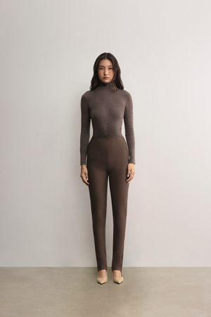 Standing model styling the mocha Mona Full Needle Rib Merino Wool Turtle Neck Top A.B.C A BRAND COLLECTIVE sleek structured fit