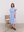 A feminine blue silhouette balancing romantic volume with modern minimalist tailoring.