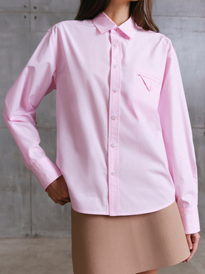 Model wearing pink MOREE relaxed shirt by A.B.C A BRAND COLLECTIVE, soft drape and comfortable movement in cotton fabric.