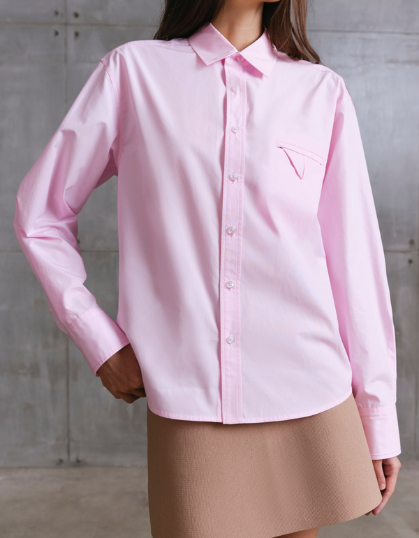 Model wearing pink MOREE relaxed shirt by A.B.C A BRAND COLLECTIVE, soft drape and comfortable movement in cotton fabric.
