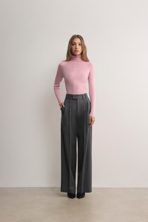 Female model wearing charcoal Malvern Pleat Front Trousers from A.B.C A BRAND COLLECTIVE.