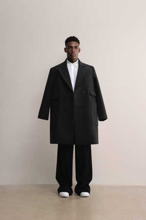 Model wearing the A.B.C A BRAND COLLECTIVE Rye wool coat showcasing its double-breasted design and insulation.