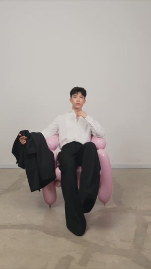 Sitting model showcasing black Parkville Wide Leg Trousers ABrandCollective durable luxury wool fabric