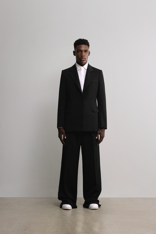 Male model wears the woven items from woven collection.